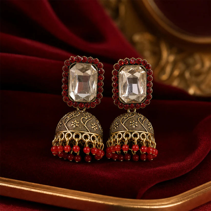 Red stone antique gold jhumka earrings with clear center stud design