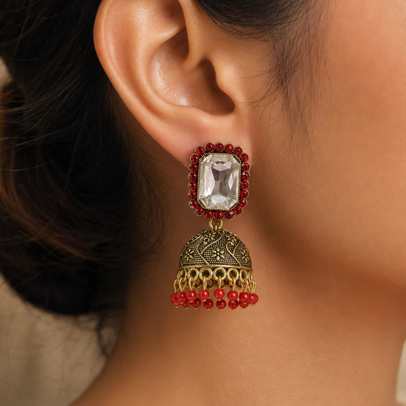 Red stone antique gold jhumka earrings with clear center stud design