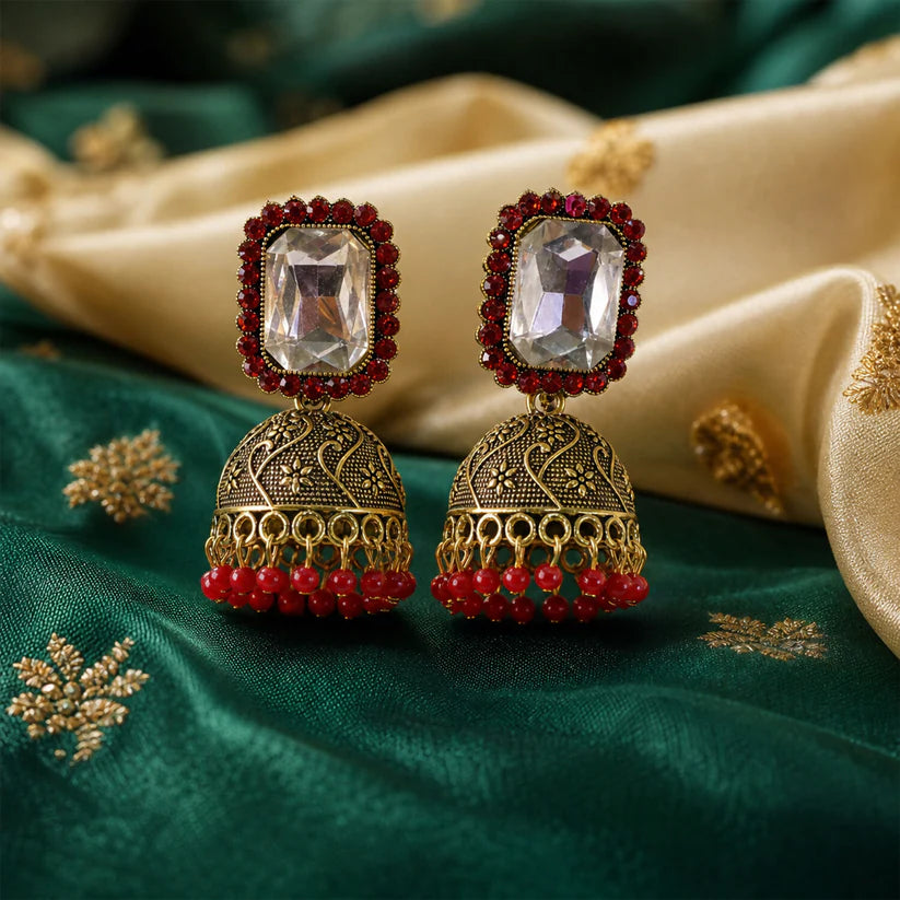 Red stone antique gold jhumka earrings with clear center stud design